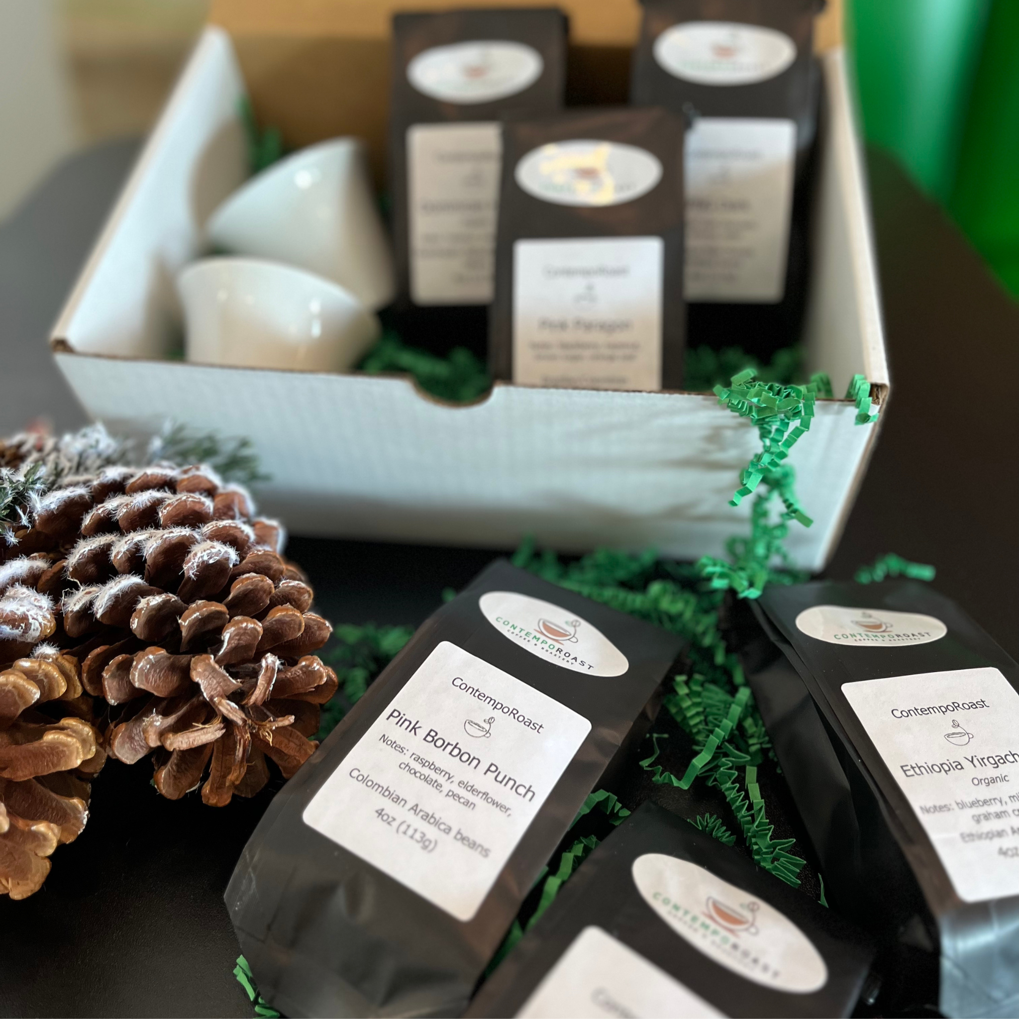 two 3oz porcelain notNeutral Cala tasting cups with either the Bright set or Classical set of three 4oz bags of coffee in a gift box