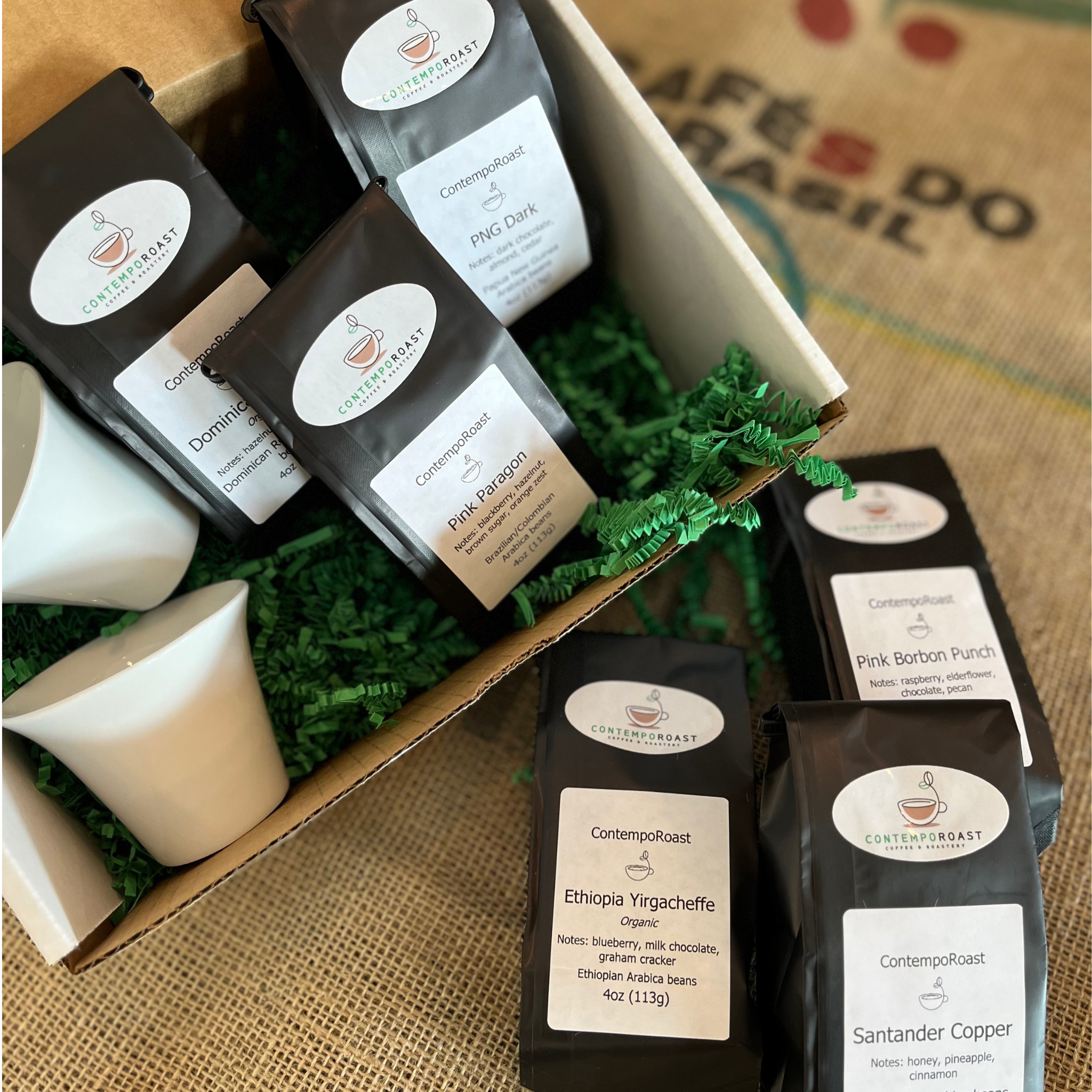 two 3oz porcelain notNeutral Cala tasting cups with either the Bright set or Classical set of three 4oz bags of coffee in a gift box