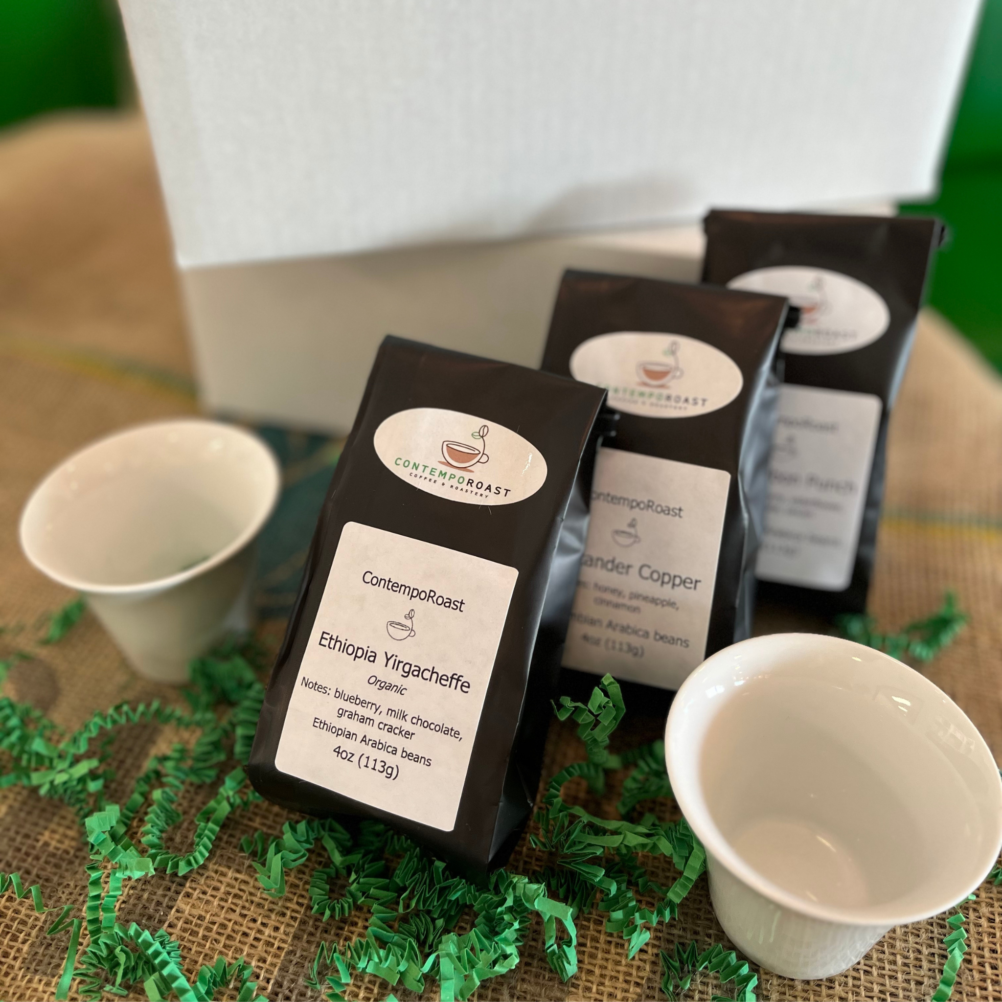 two 3oz porcelain notNeutral Cala tasting cups with the Bright set of three 4oz bags of coffee