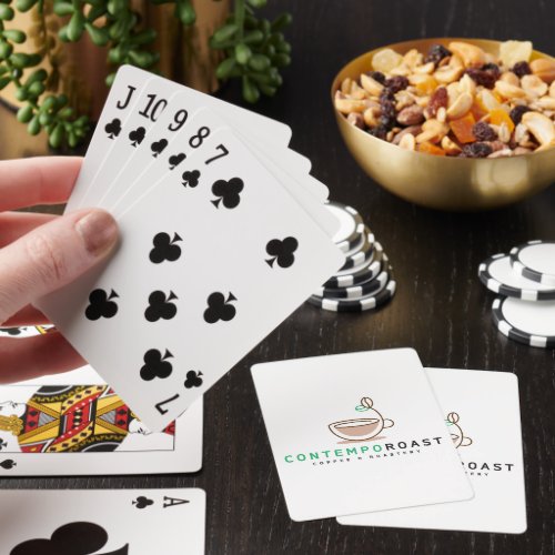 a scene where a woman holds a hand of cards, with two ContempoRoast cards showing on the table