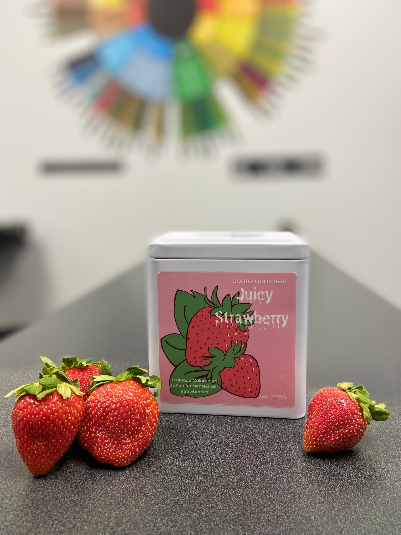 Juicy Strawberry 8oz keepsake tin surrounded by fresh strawberries