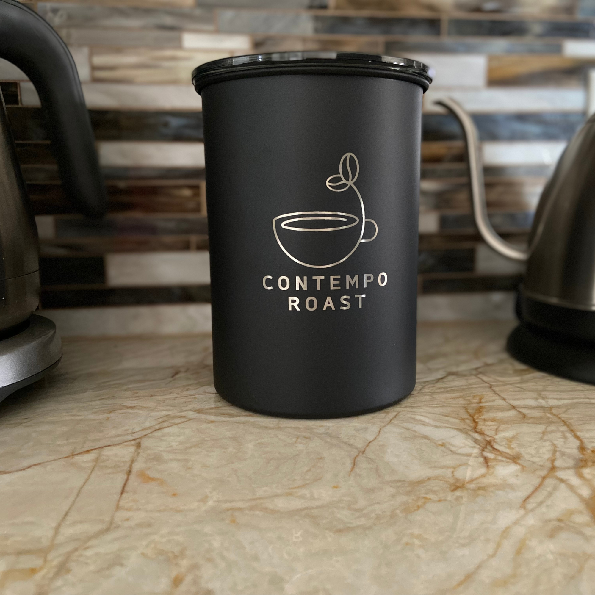 matte black canister with the ContempoRoast logo etched on the front, sitting on a kitchen countertop